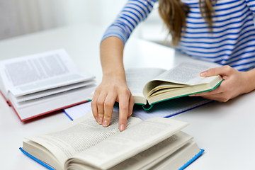 Image showing close up of student girl reading books at home