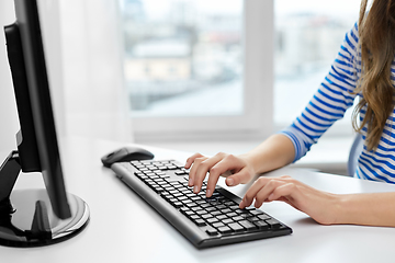 Image showing close up of teenage girl with computer at home