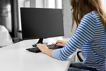 Image showing close up of teenage girl with computer at home