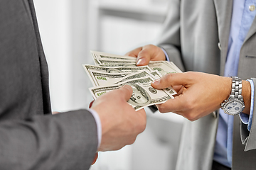 Image showing close up of businessmen's hands holding money