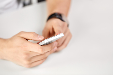 Image showing close up of male hands with smartphone