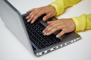 Image showing african american student girl typing on laptop