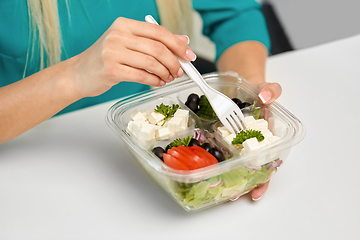 Image showing hands of woman eating take out food from container