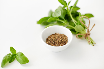 Image showing fresh basil and dry seasoning on white background