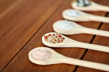 Image showing spoons with salt and spices on wooden table