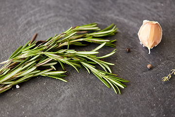 Image showing rosemary, garlic and black pepper on stone surface