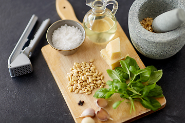 Image showing ingredients for basil pesto sauce on wooden board