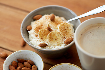 Image showing oatmeal with banana and almond on wooden table