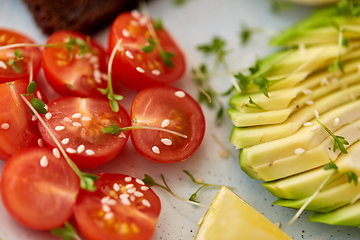 Image showing cherry tomatoes and sliced avocado with thyme