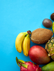 Image showing different exotic fruits on blue background