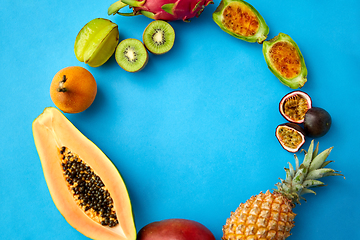 Image showing different exotic fruits on blue background