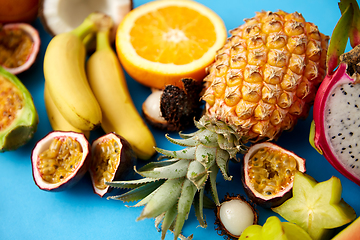 Image showing different exotic fruits on blue background