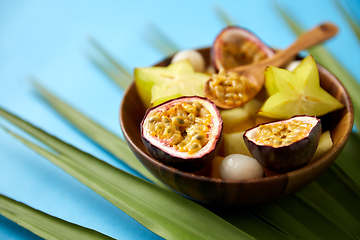 Image showing mix of exotic fruits in wooden plate with spoon