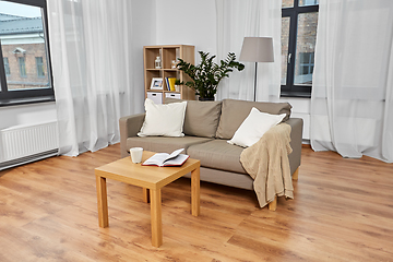 Image showing sofa, coffee and book on table at cozy home