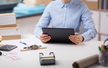 Image showing woman with tablet pc and clipboard at post office