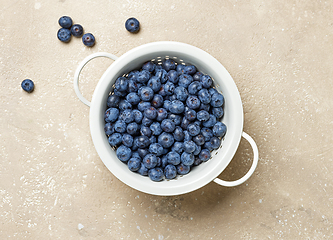 Image showing fresh blueberries in a white metal sieve