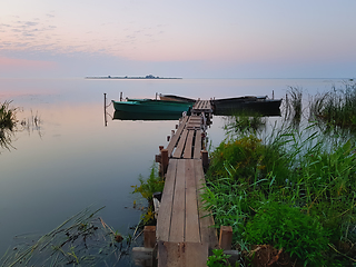 Image showing Dawn begins. Wooden Pier for Boats on the Lake Shore