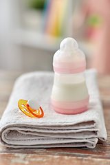 Image showing bottle with baby milk formula, soother and towel