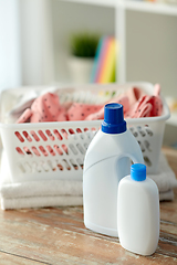 Image showing baby clothes in laundry basket with detergent