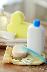 Image showing baby accessories for bathing on wooden table