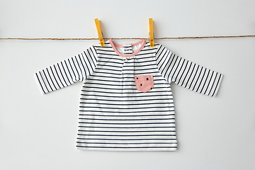 Image showing shirt for baby girl hanging on rope with pins