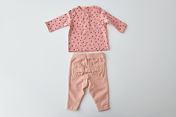 Image showing pink shirt and pants for baby girl over white