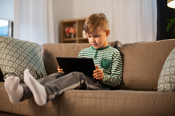 Image showing happy little boy with tablet computer at home