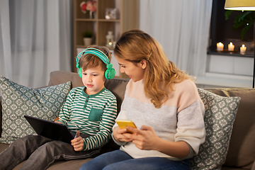 Image showing mother and son using gadgets at home