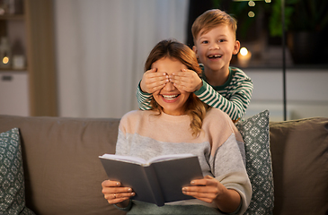 Image showing happy smiling mother playing with her son at home