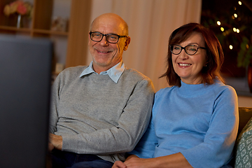 Image showing happy senior couple watching tv at home