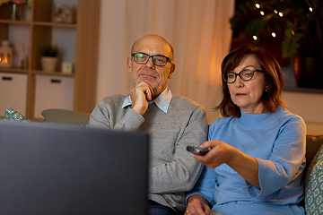 Image showing senior couple watching tv at home in evening