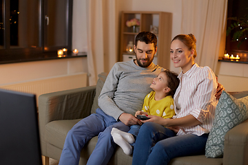 Image showing happy family watching tv at home at night