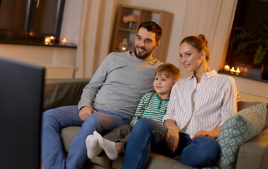 Image showing happy family watching tv at home at night