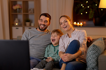 Image showing happy family watching tv at home at night