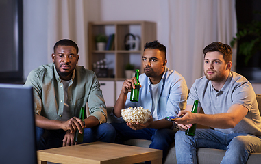 Image showing male friends with beer watching tv at home