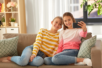 Image showing happy girls taking selfie with smartphone at home