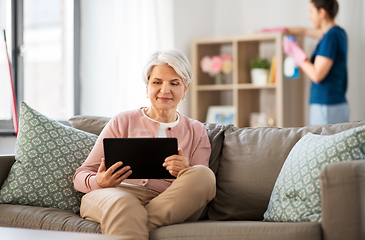 Image showing old woman with tablet pc and housekeeper at home