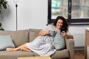 Image showing woman with smartphone drinking coffee at home