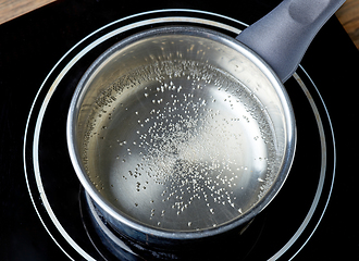Image showing kettle of boiling water on electric induction hob