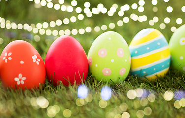 Image showing row of colored easter eggs on artificial grass