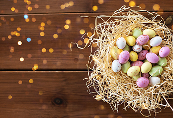 Image showing easter eggs in straw nest on wooden table