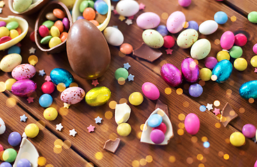 Image showing chocolate eggs and candy drops on wooden table