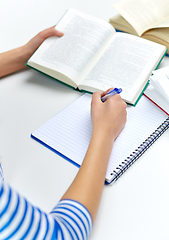 Image showing close up of student girl writing to exercise book