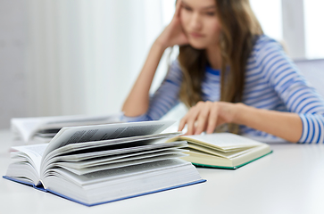 Image showing close up of student girl reading books at home