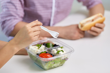 Image showing hands of woman eating take out food from container