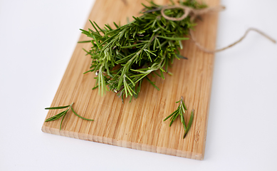 Image showing bunch of rosemary on wooden cutting board