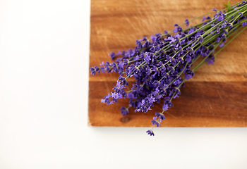 Image showing bunch of lavender flowers on wooden board