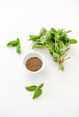 Image showing fresh basil and dry seasoning on white background