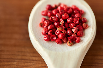 Image showing close up of pink peppercorns on wooden spoon
