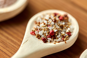 Image showing spoon with salt and spices on wooden table